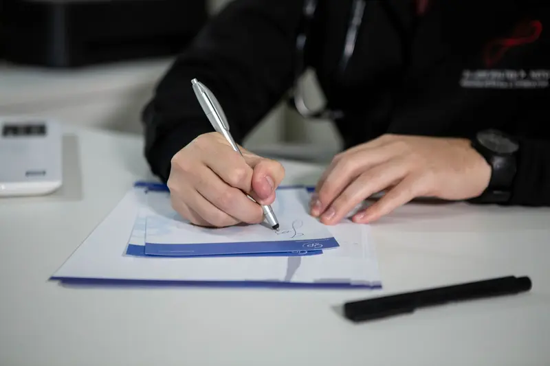 Doctor's hand writing a prescription on paper